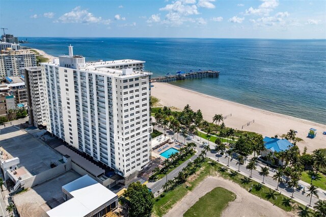 birds eye view of property with a view of the beach and a water view