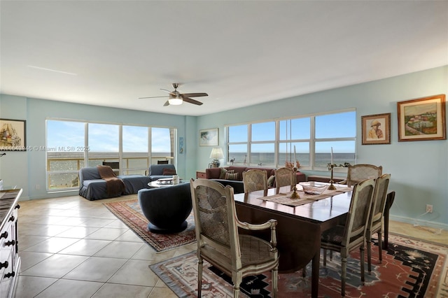 dining area featuring light tile patterned floors, ceiling fan, and baseboards