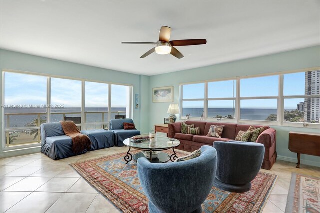 living room with ceiling fan and light tile patterned floors