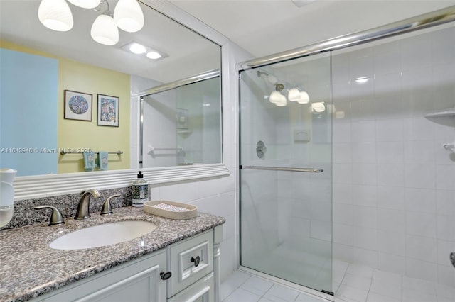 full bath with a stall shower and vanity