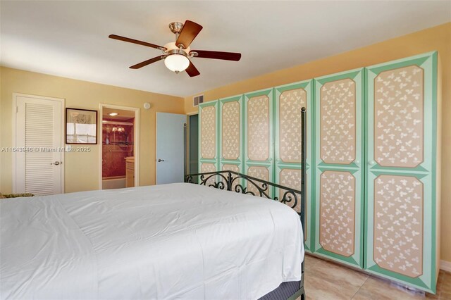 clothes washing area featuring light tile patterned flooring and stacked washer and dryer