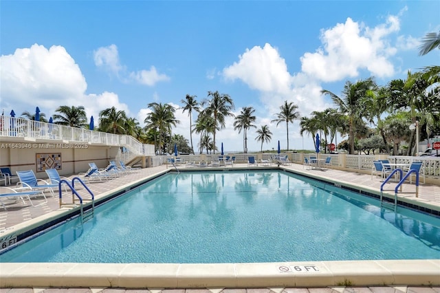 community pool featuring a patio area and fence