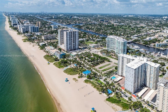 birds eye view of property with a view of the beach, a city view, and a water view