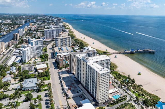 birds eye view of property with a beach view and a water view