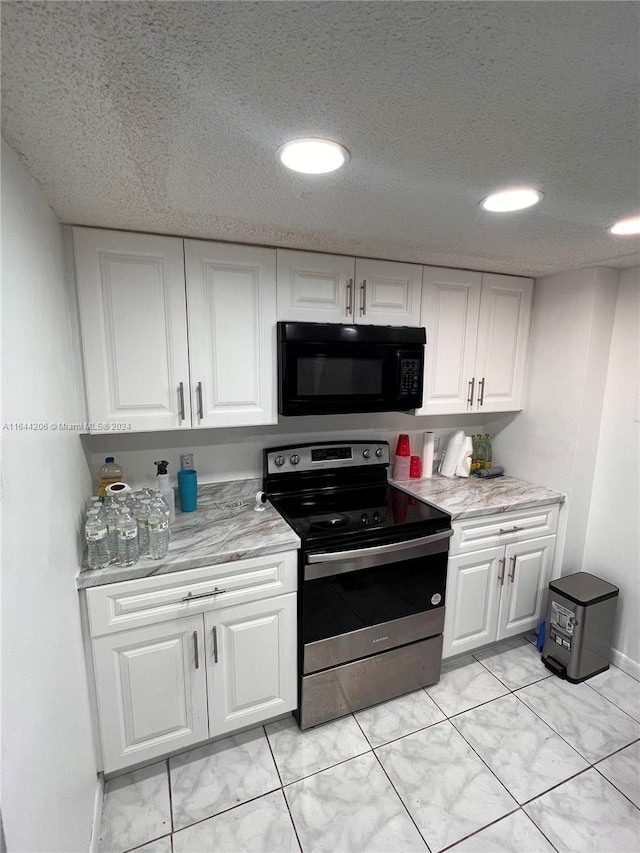 kitchen featuring white cabinets, light tile patterned floors, electric range, and light stone countertops