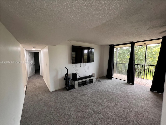 unfurnished living room featuring light carpet and a textured ceiling