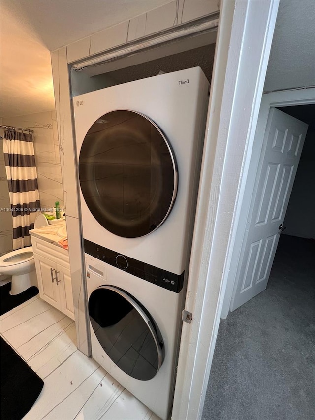 laundry area featuring stacked washer / dryer