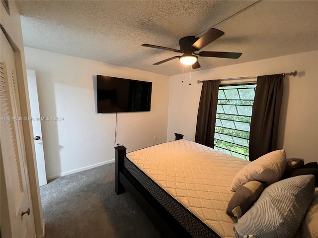 bedroom featuring ceiling fan, carpet flooring, and a textured ceiling