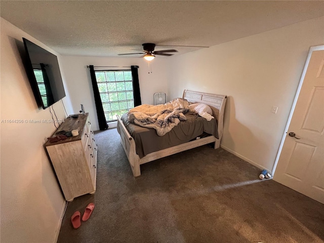 bedroom with dark colored carpet, ceiling fan, and a textured ceiling