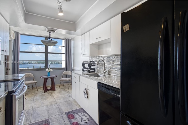 kitchen featuring sink, decorative backsplash, hanging light fixtures, black appliances, and white cabinets