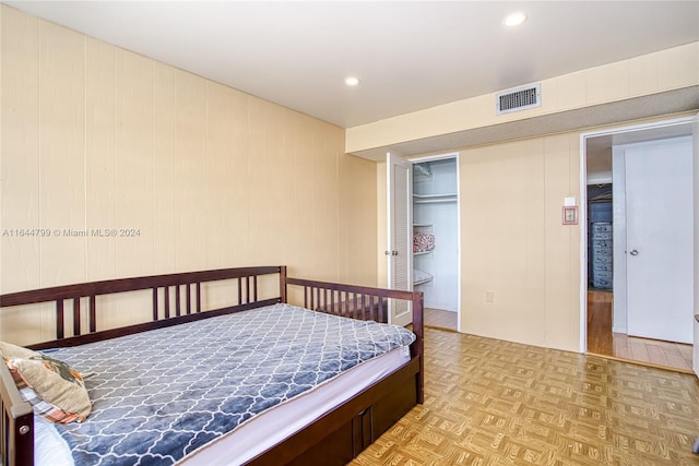 bedroom with light parquet flooring and a closet