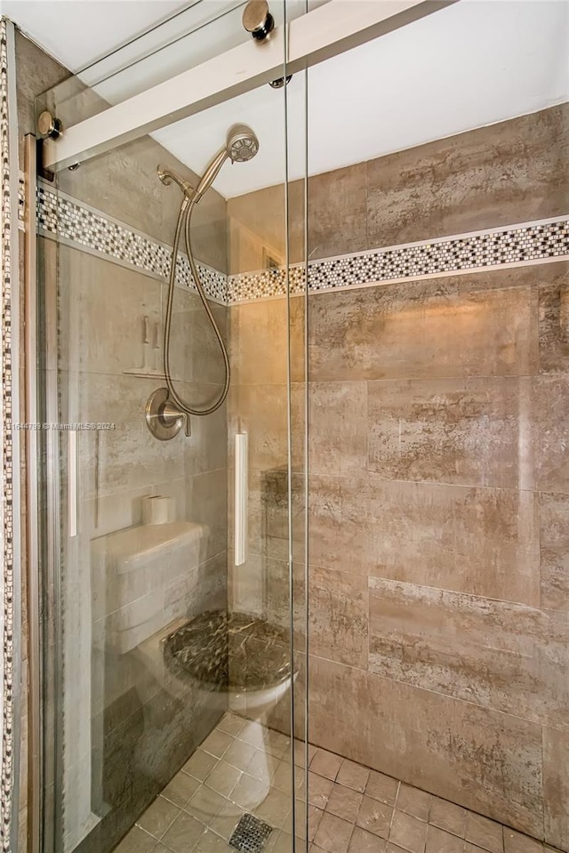 bathroom featuring a shower with door