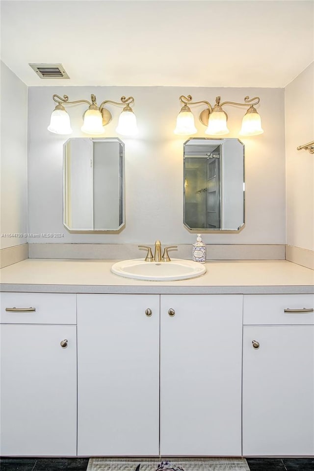 bathroom featuring tile patterned flooring and vanity