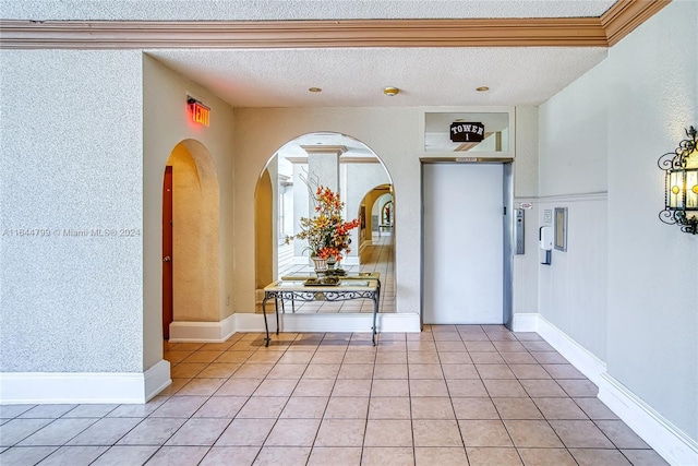 tiled entrance foyer with a textured ceiling