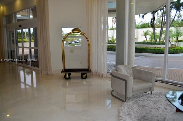 foyer entrance featuring light tile patterned floors and a healthy amount of sunlight