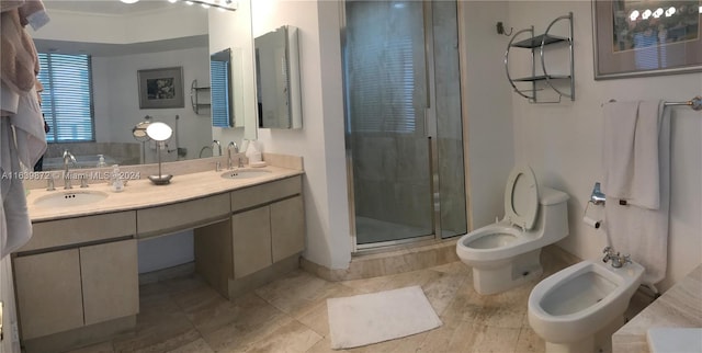 bathroom with vanity, toilet, a bidet, and an enclosed shower