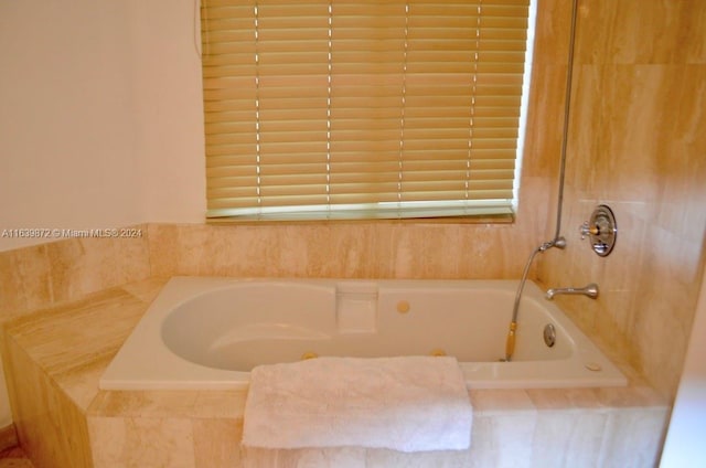 bathroom with a relaxing tiled tub