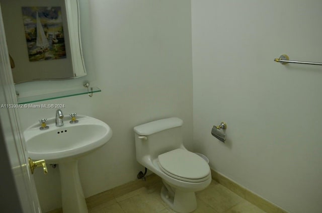 bathroom with tile patterned flooring and toilet