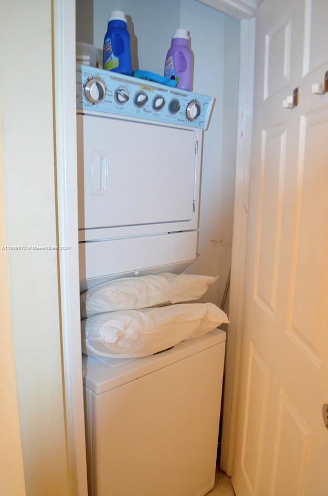 laundry area with stacked washing maching and dryer