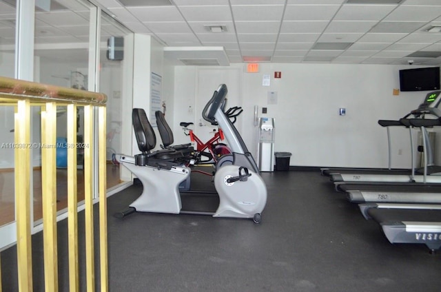 workout area featuring a paneled ceiling