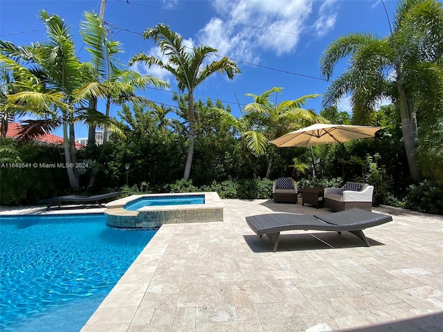 view of pool with an in ground hot tub and a patio area