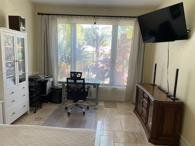 office featuring a wealth of natural light and light tile patterned flooring