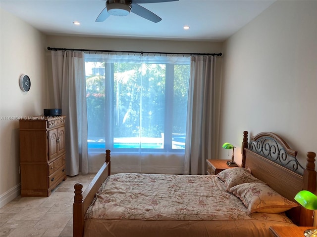 tiled bedroom with multiple windows and ceiling fan