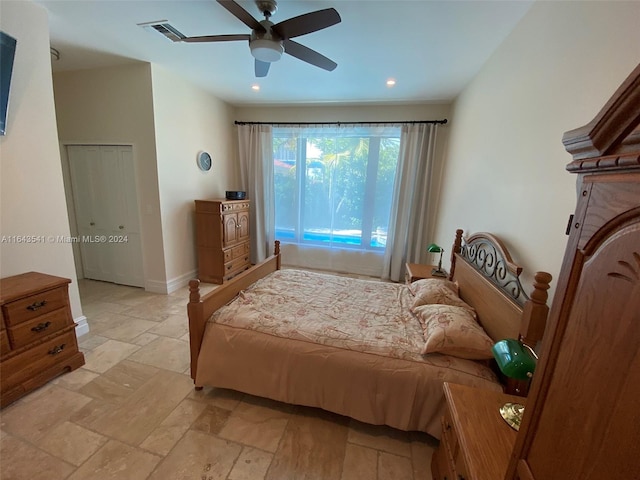 tiled bedroom with ceiling fan