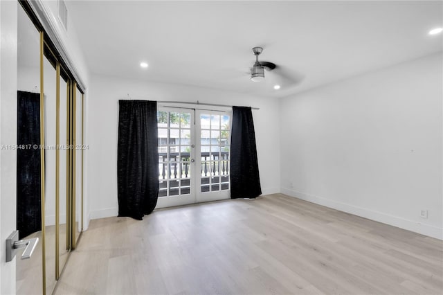 spare room featuring ceiling fan, light hardwood / wood-style floors, and french doors