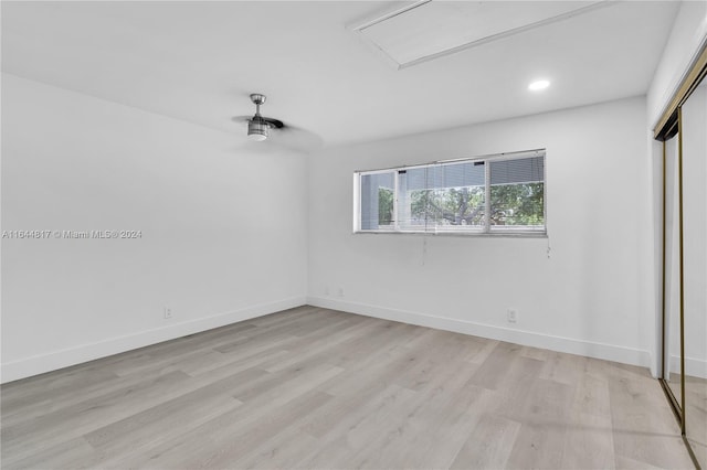 unfurnished bedroom featuring a closet and light hardwood / wood-style floors