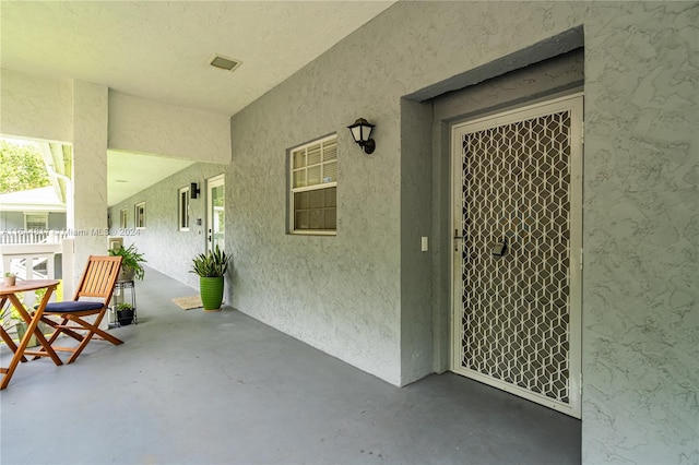 doorway to property featuring a patio area