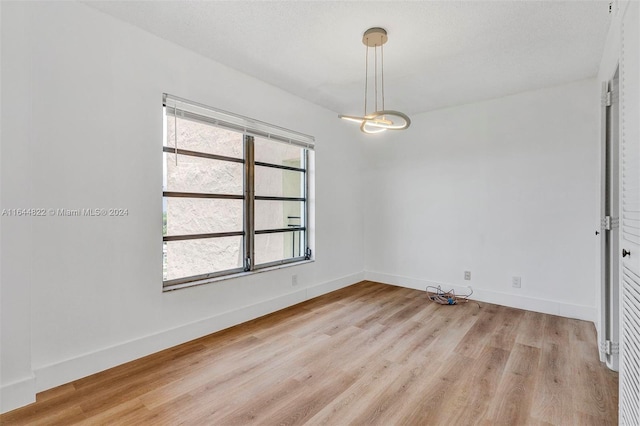 unfurnished room with light wood-type flooring