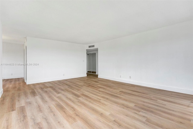 unfurnished room with light hardwood / wood-style flooring