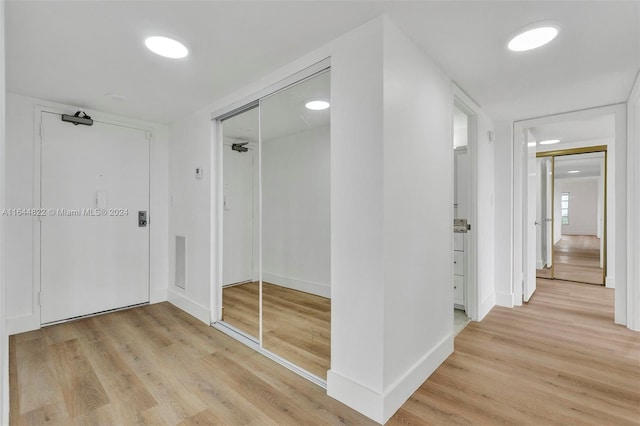 hall with light hardwood / wood-style flooring