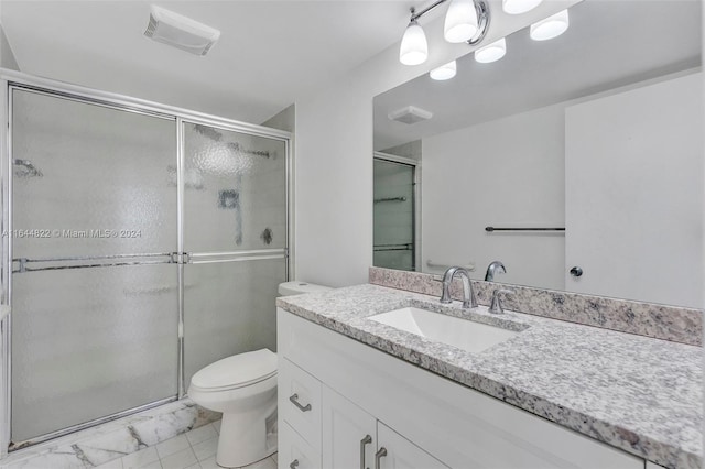 bathroom featuring toilet, an enclosed shower, tile patterned floors, and vanity