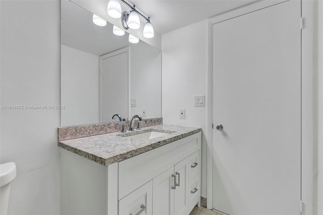 bathroom featuring toilet, vanity, and tile patterned floors