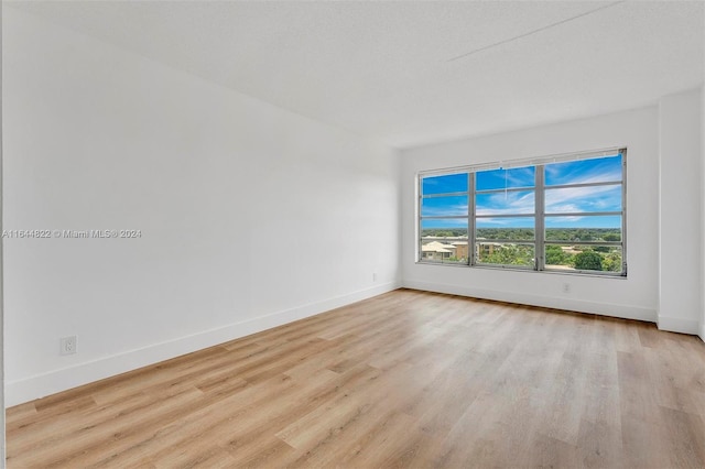 unfurnished room with light hardwood / wood-style flooring