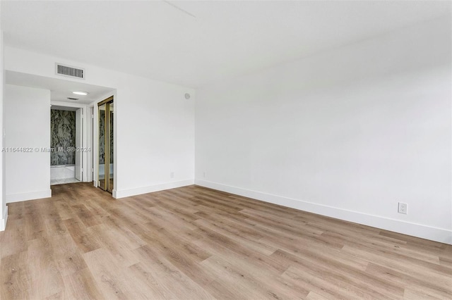 spare room with light hardwood / wood-style floors