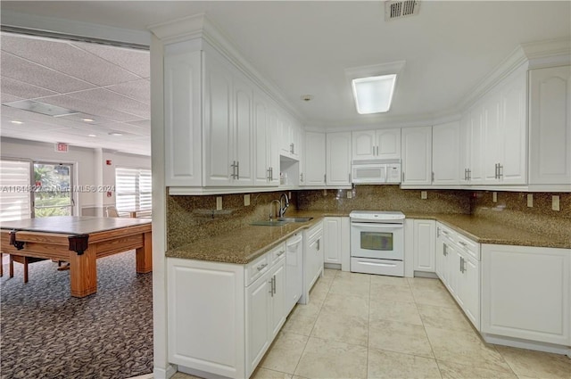 kitchen with decorative backsplash, white cabinetry, and white appliances