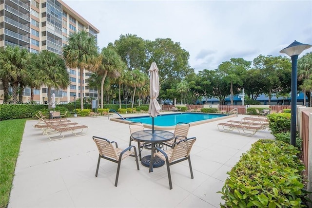 view of swimming pool with a patio