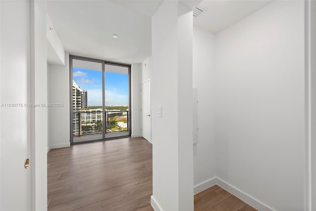 interior space featuring hardwood / wood-style floors and a wall of windows