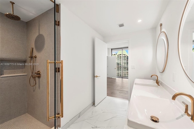 bathroom featuring vanity and a shower with door