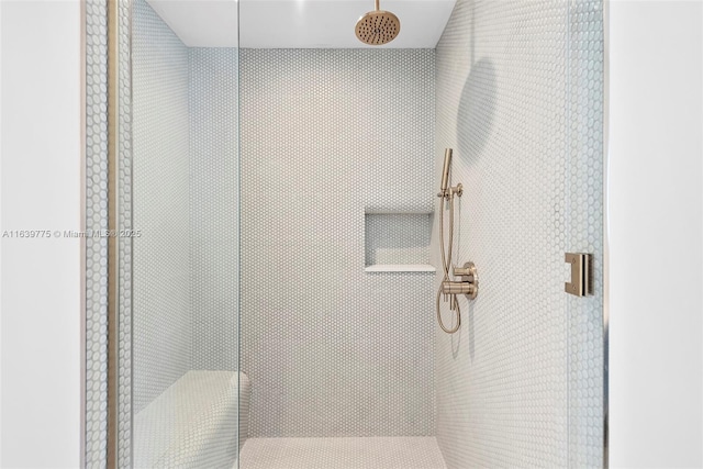 bathroom featuring a shower with door