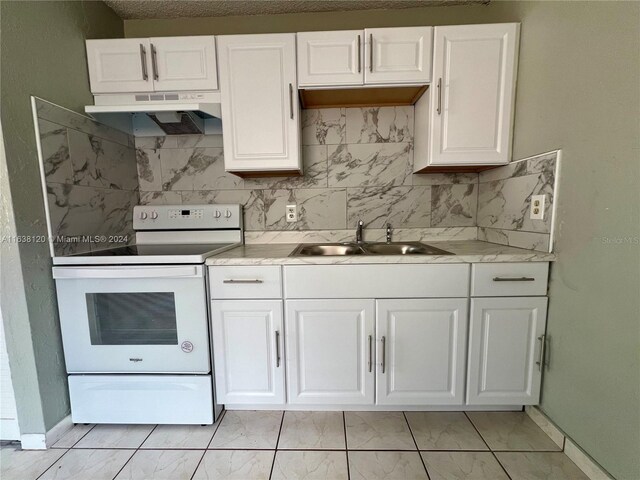 kitchen featuring sink, white cabinetry, light tile patterned floors, and white electric range