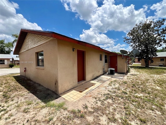 back of house featuring central AC unit