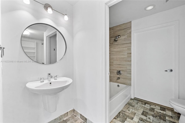 bathroom featuring  shower combination and toilet