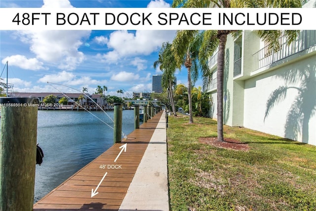 view of dock featuring a water view and a lawn