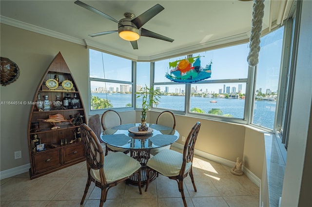 sunroom / solarium featuring a water view and ceiling fan