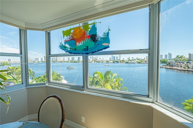 unfurnished sunroom featuring a water view