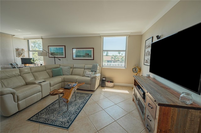 living room featuring light tile patterned floors and crown molding